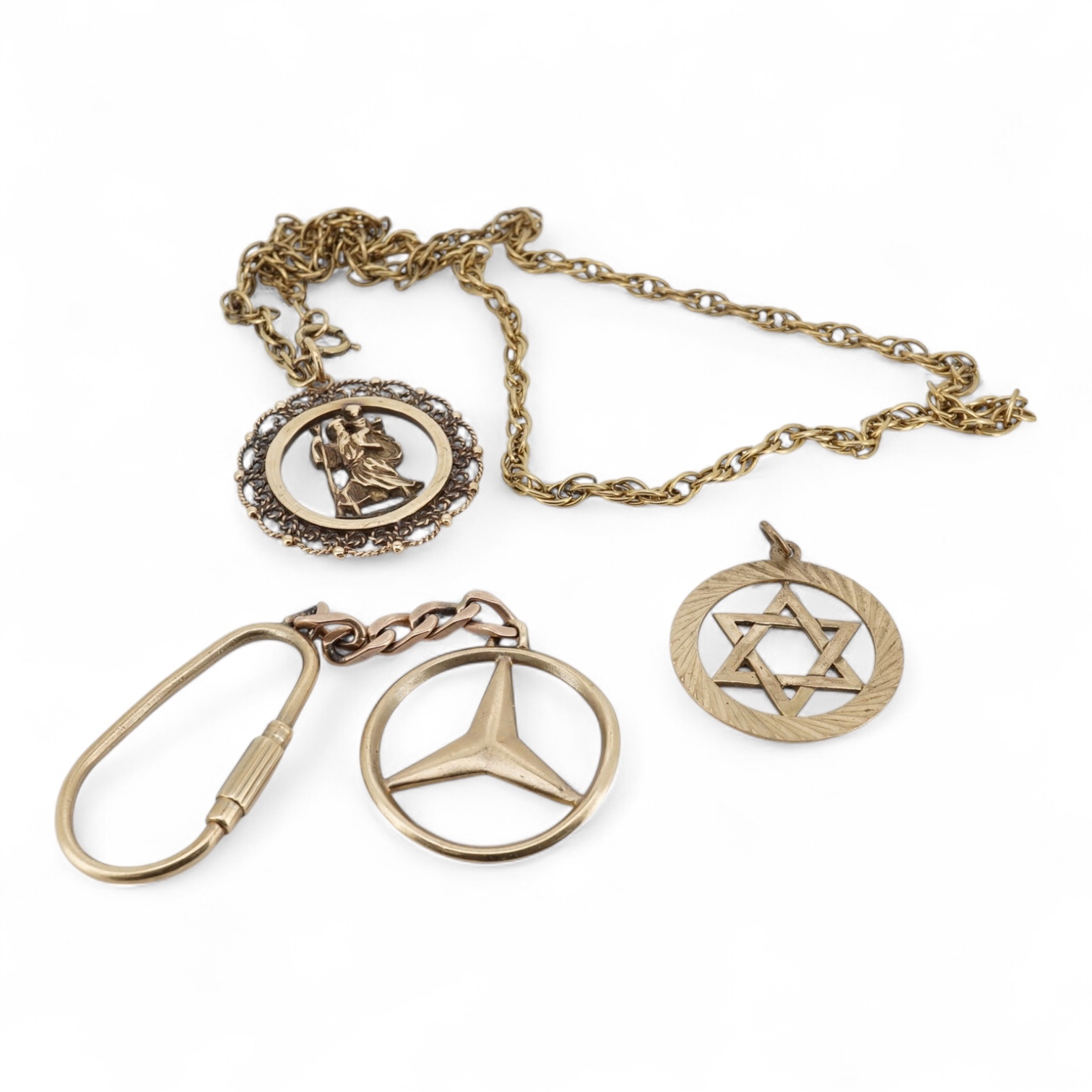 A modern 9ct gold Star of David pendant, diameter 22mm, a 9ct gold St Christopher's pendant on a 9ct chain and an Italian Uno-A-Erre 9k Mercedes insignia keyring, gross weight 22.2 grams.